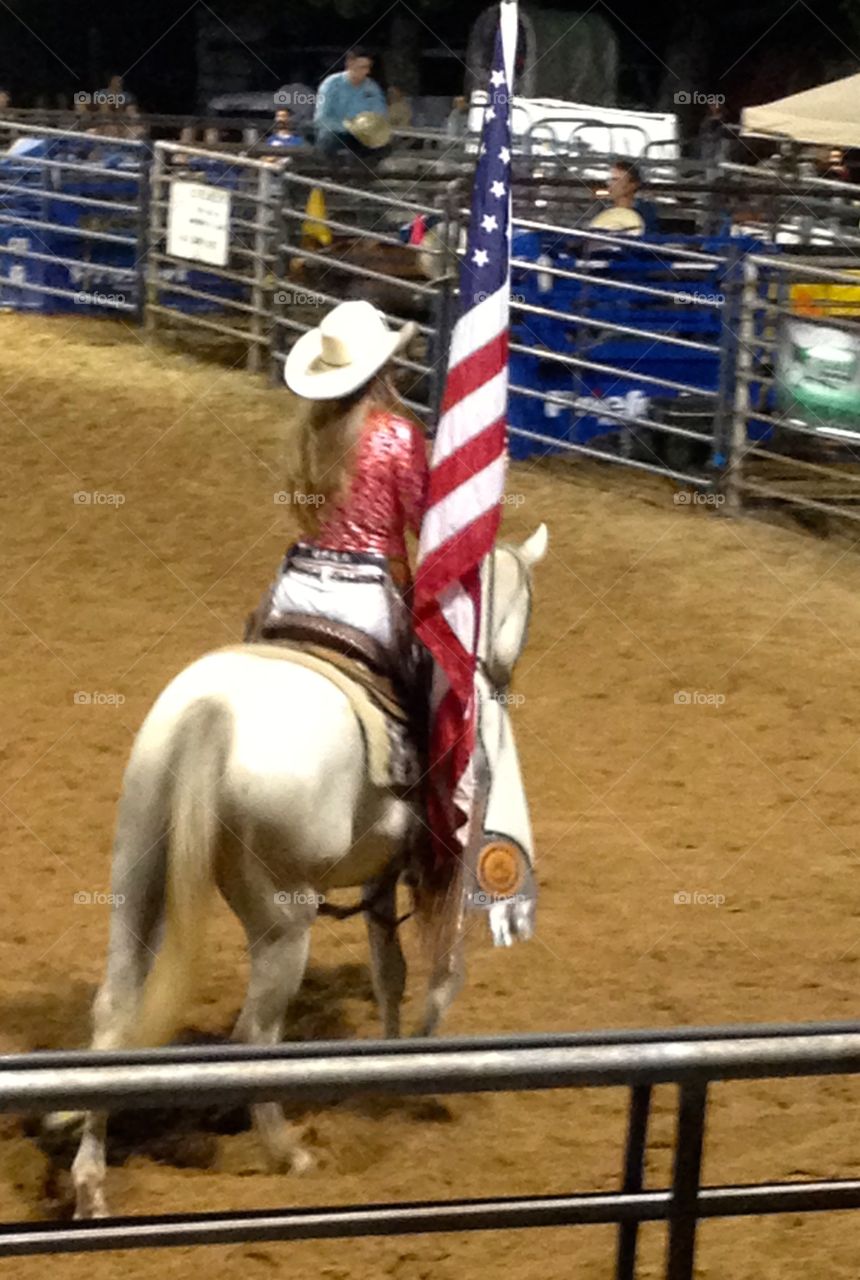 Cowgirl rodeo queen with flag