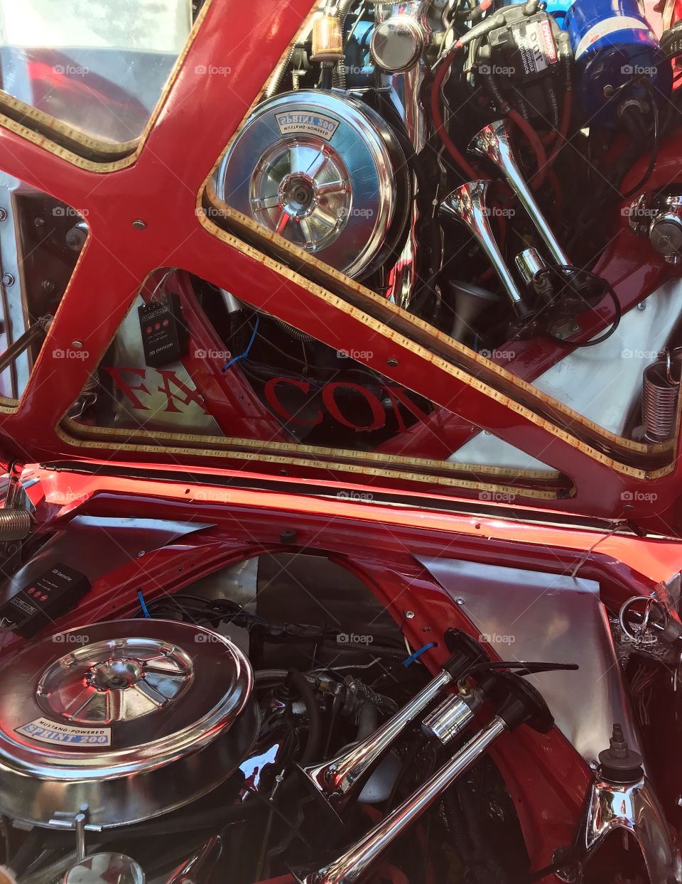 Vintage red car motor with interior mirrored hood close up