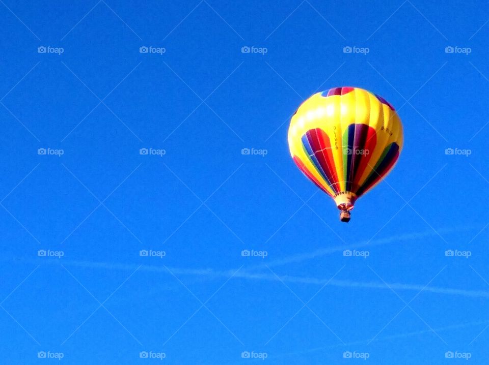 blue sky with yellow balloon