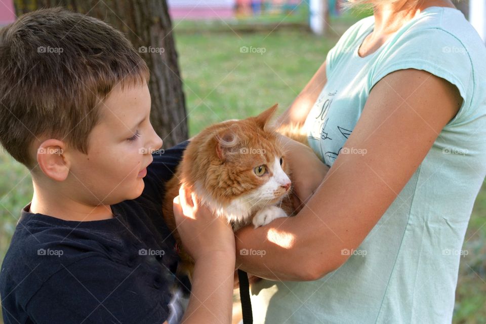 woman and child with ginger cat outdoor family