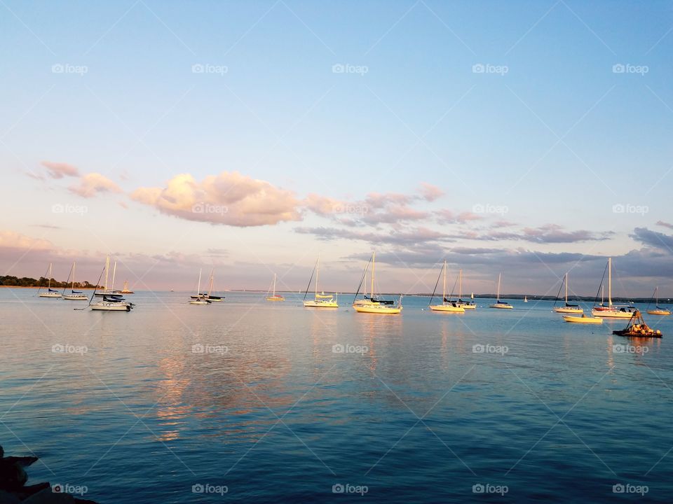 A fleet of sail boats sit in the Raritan bay in Perth Amboy, Nj.