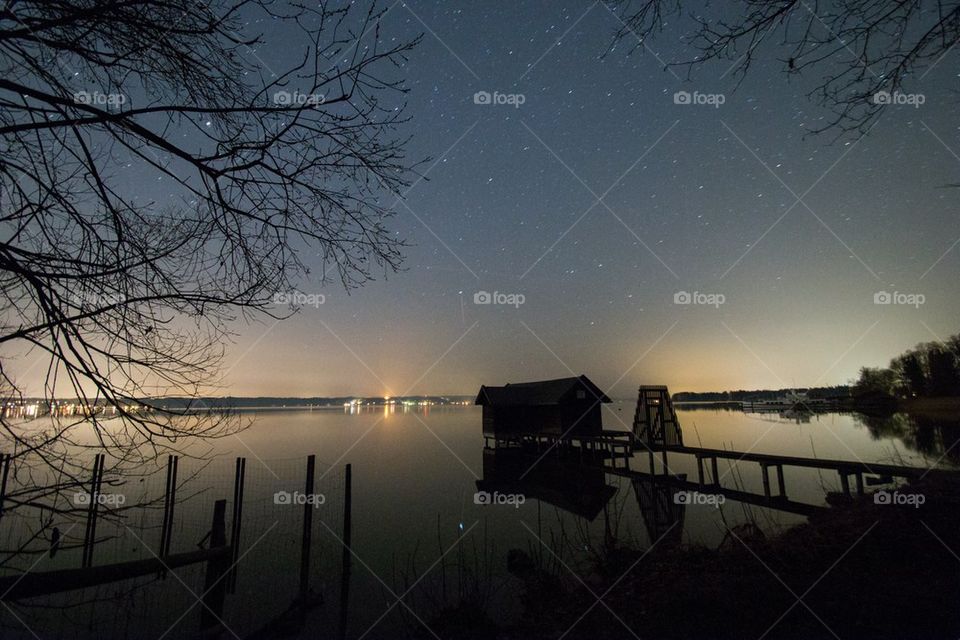 Scenics view of idyllic lake with stars in the sky