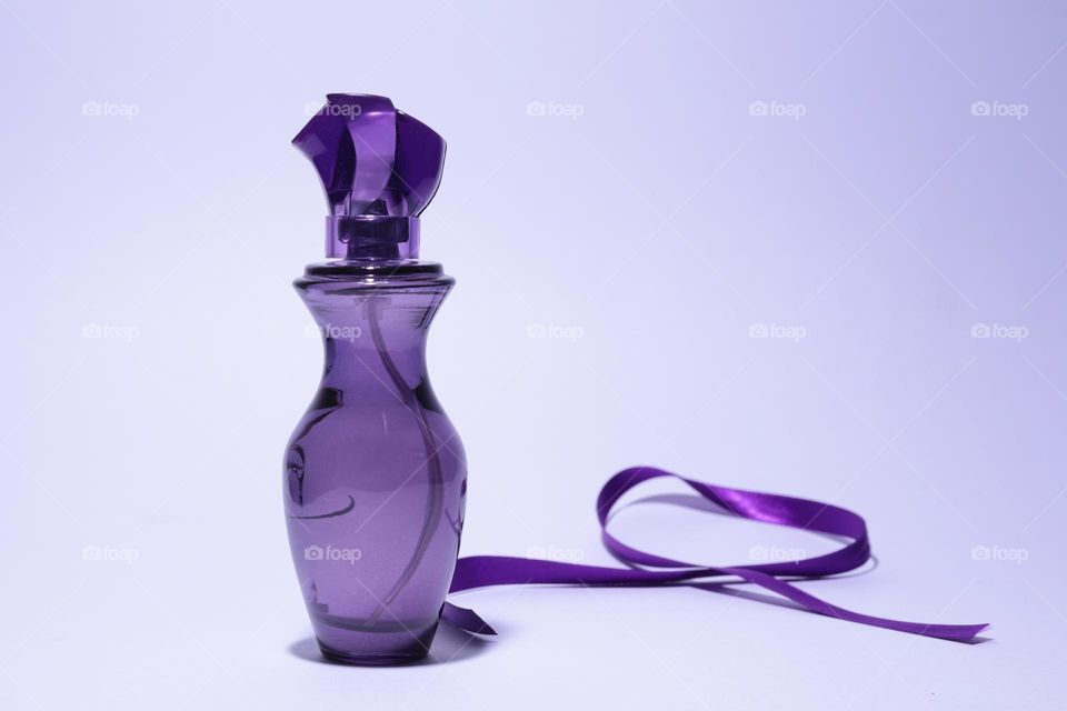 Perfume with a purple ribbon