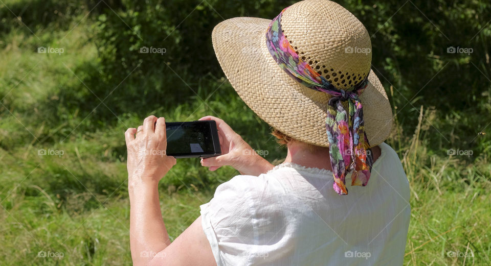 Phone. Camera phoneTourist taking a picture with a smartphone cell phone mobile phone camera 