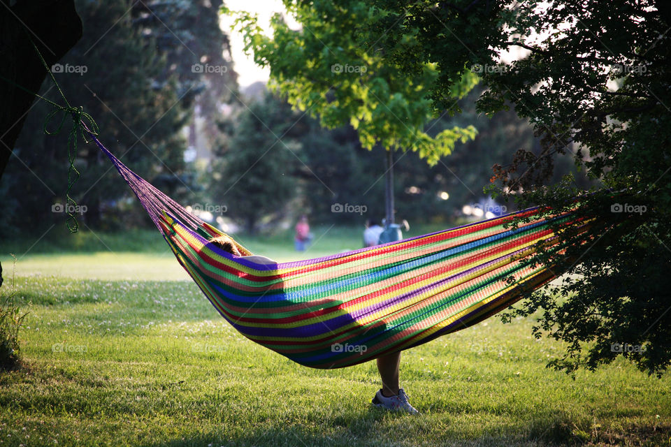 Relaxing in a hammock in the park