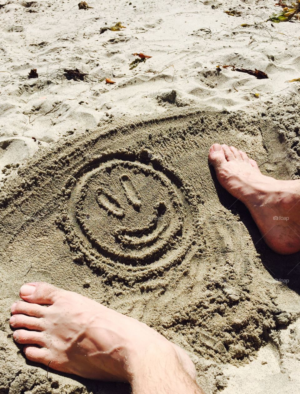 Drawing smiley faces in the sand on one of Malibu's hidden beaches. 