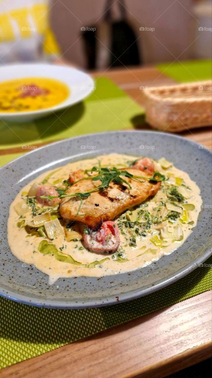 a dish with meat, vegetables and sauce