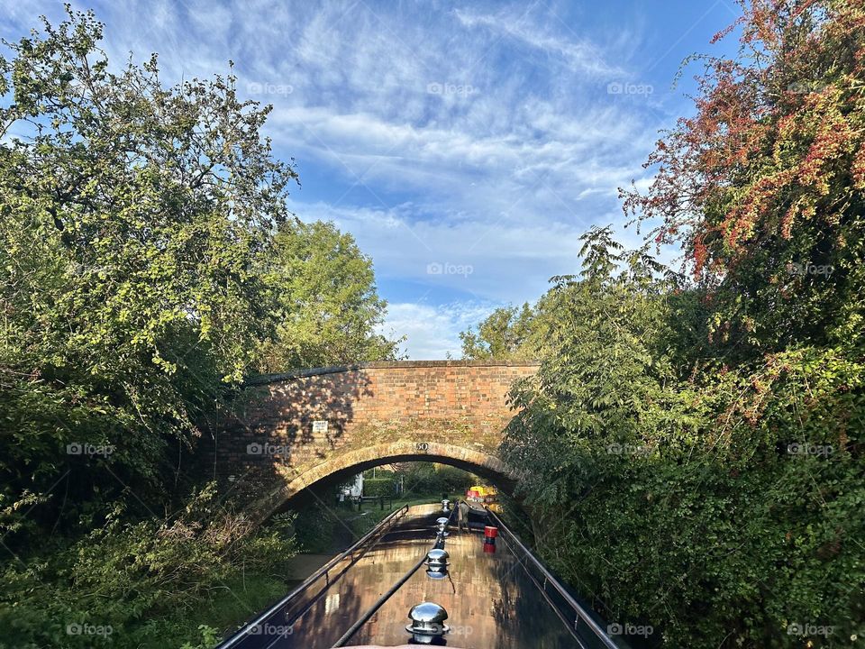 Brick brdge 50 along Oxford canal near Rugby Newbold in England historical narrowboat cruise vacation rural countryside relaxing sunny sky trees