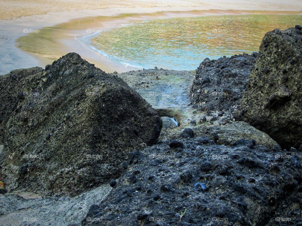 Mountain rocks on the beach.