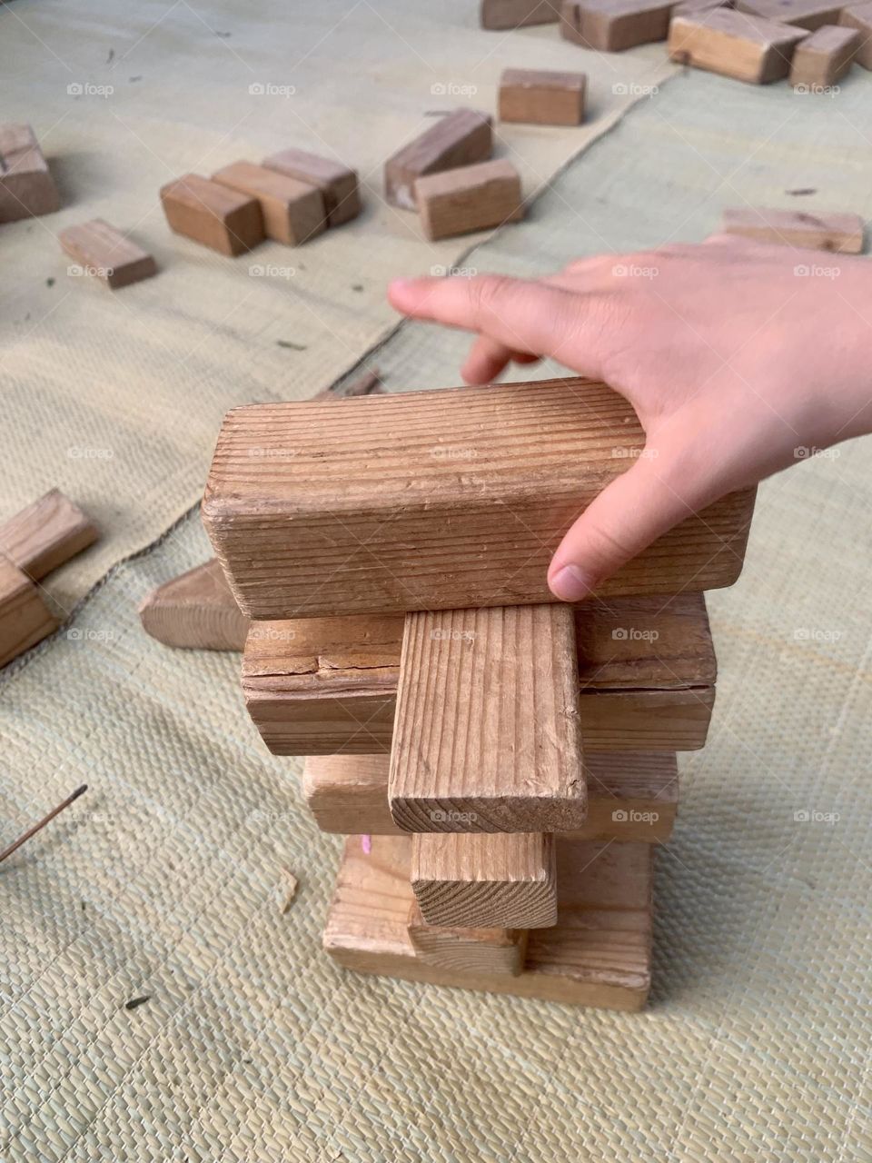Wooden blocks tower in progress 