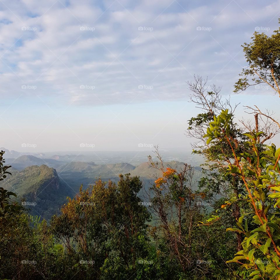 Scenic view of mountain against blue sky