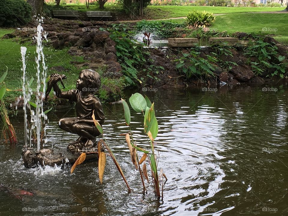 Boy with frog fountain and statue. Tyler Rose Garden, Texas. 