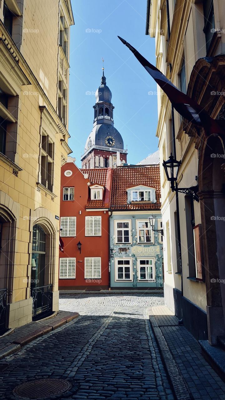 Medieval street in Riga, sunny summer day, street view, church 