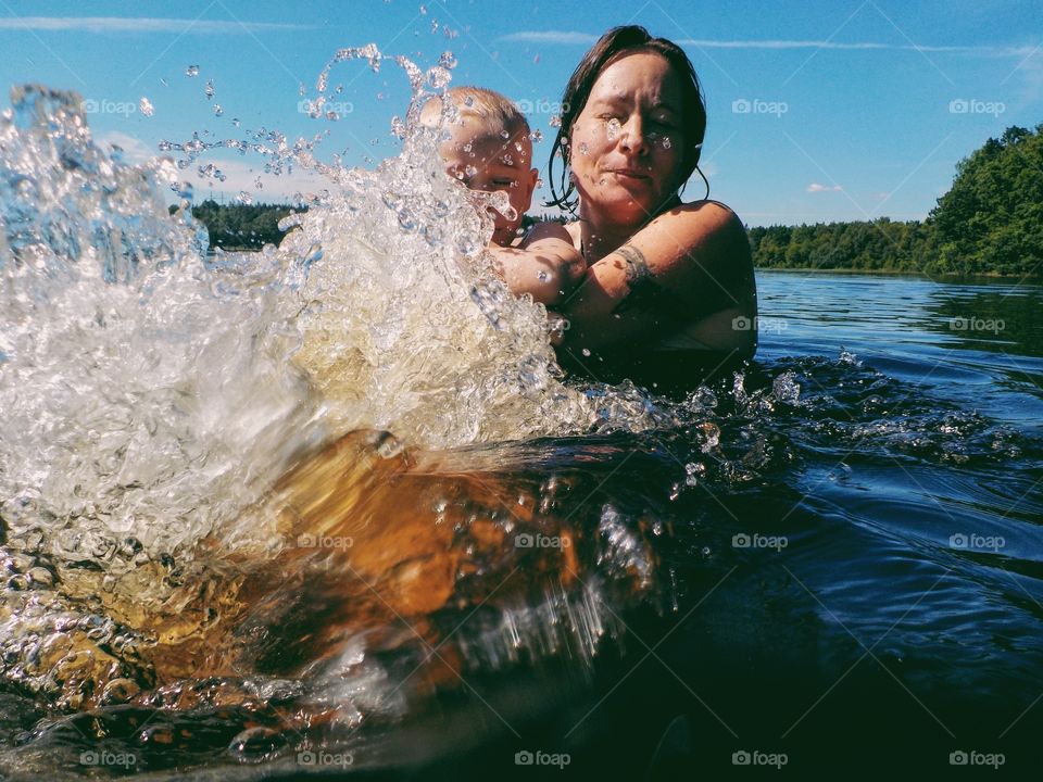 Mother and child having fun in the water