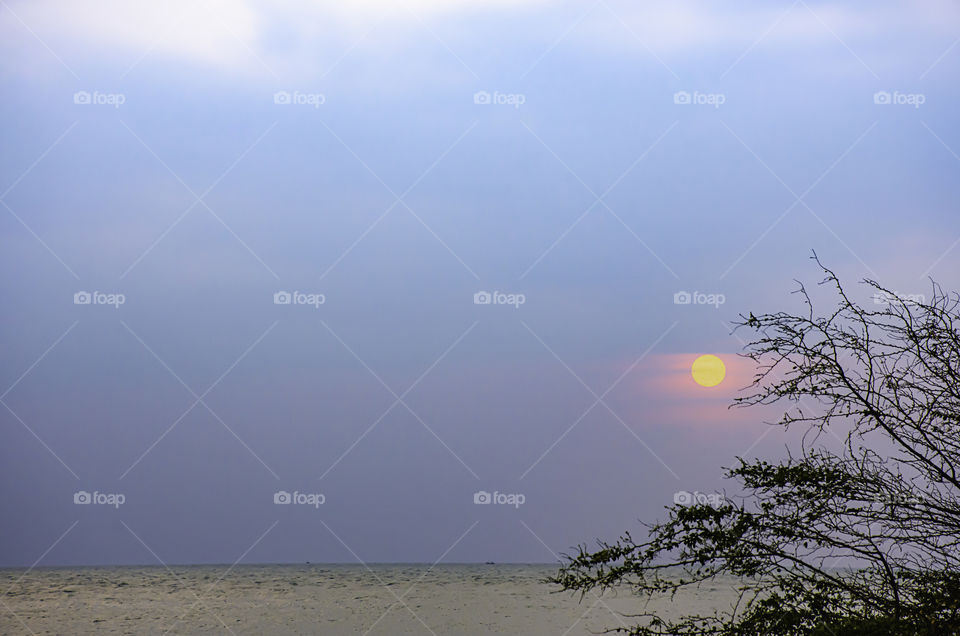 The sun in the morning that reflect the clouds and the sea.