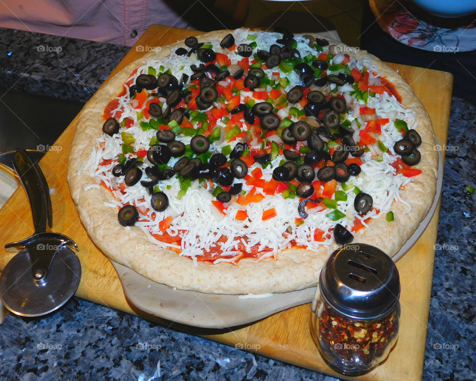 Delicious and nutritious homemade pizza with fresh, colorful vegetables, meats and a variety of spices! Grab a slice!