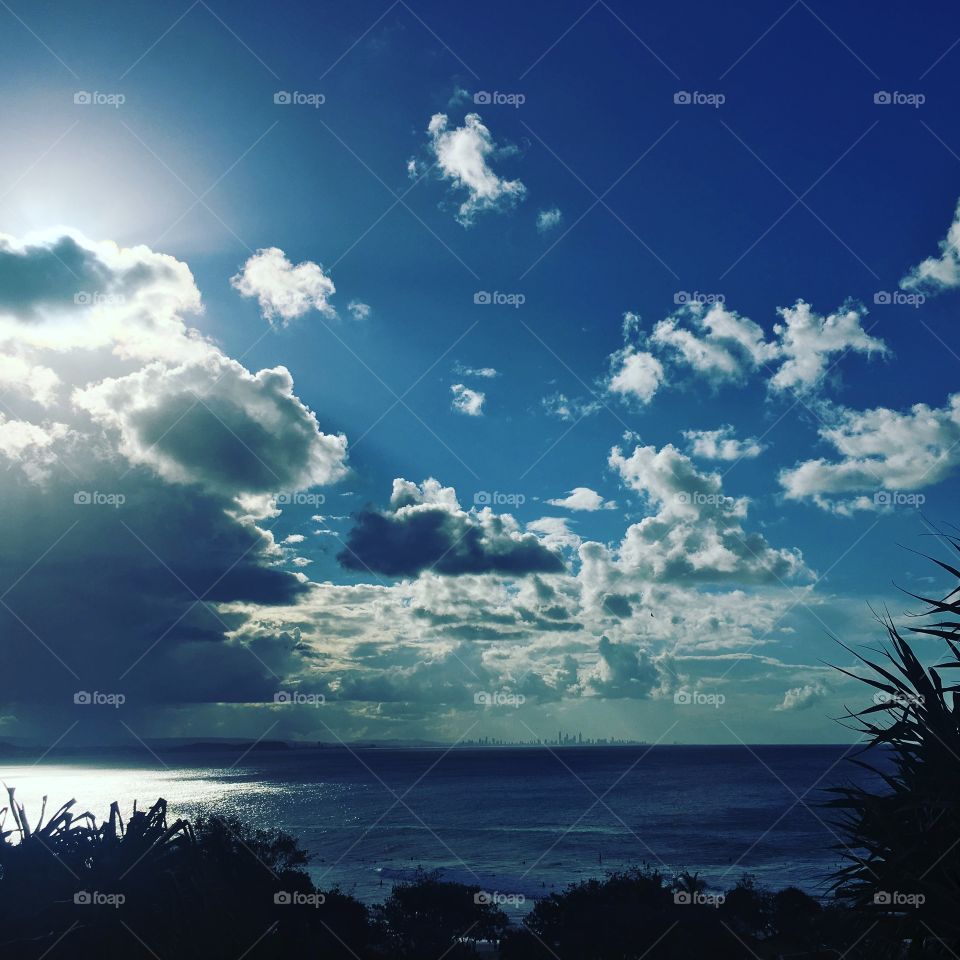 Sunny and stormy seas. Peaceful coastal views w/ city in the far distance. Watching nature’s four seasons in one day