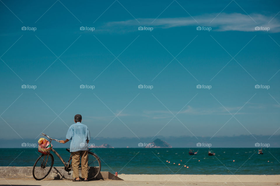 cyclist looks at the ocean