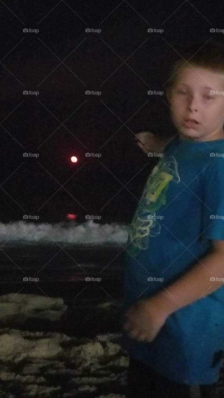 Red moon over the ocean