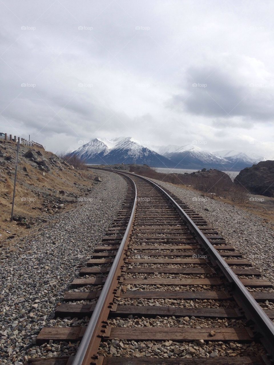 Railroad against cloudy sky