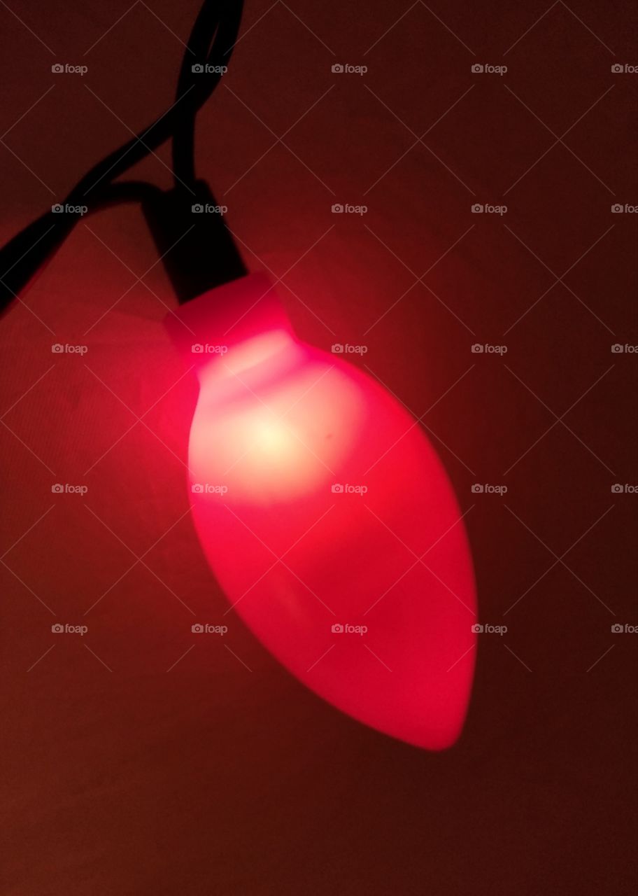 Unfiltered, beautiful, lovely close-up of a Red Christmas light bulb for the holidays