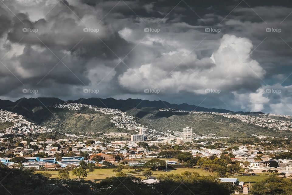 clouds hovering over the house on the hills