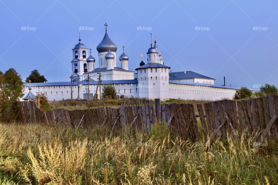 monastery behind an old wooden fence