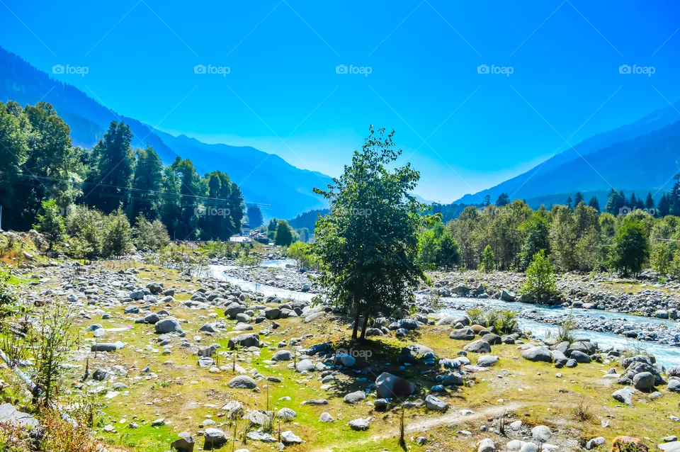 Mountain valley during bright sunny day. Beautiful natural landscape in the summer time.Mountain valley during sunny day. Natural summer landscape. Travel nature background poster concept