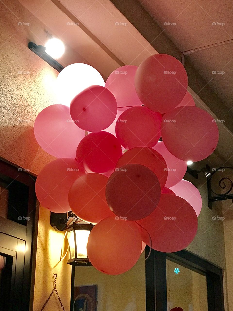 Uneven lighting for a bunch of pink balloons 