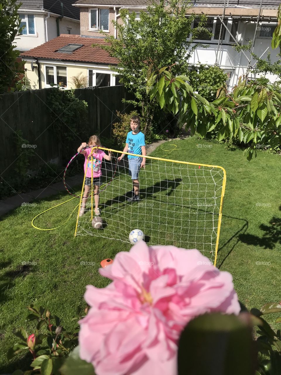 Rose, football goals and kids in the back garden having their first brake after homeschool lesson due to lockdown... 