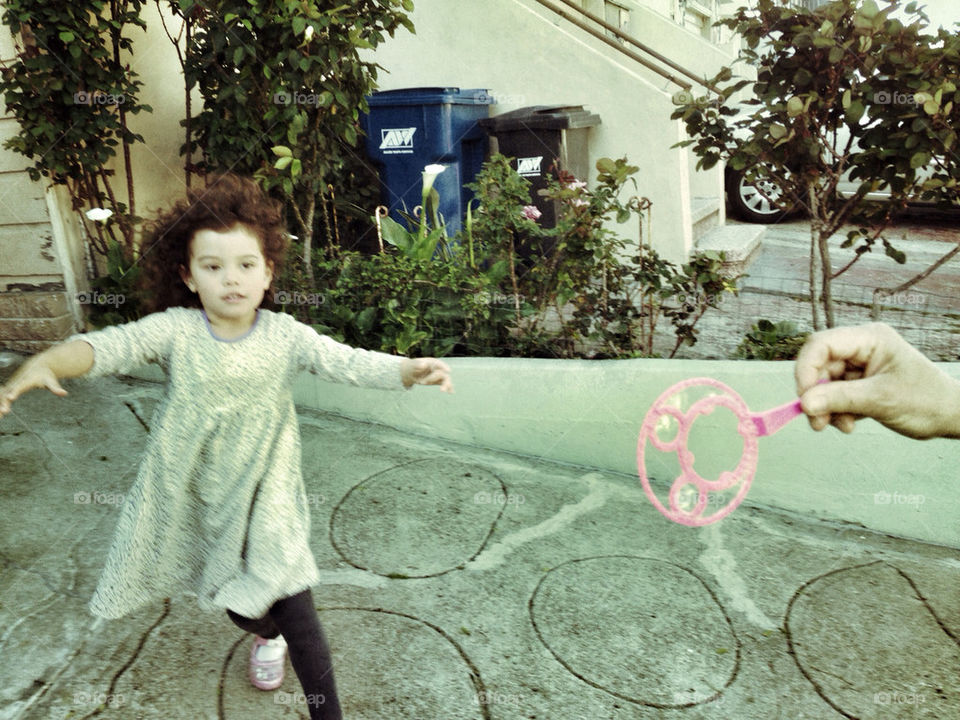 Girl Chasing Bubbles