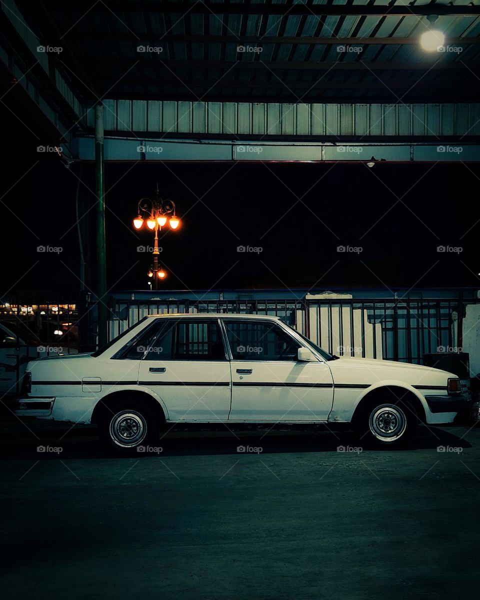 A vintage car resting in a garage.