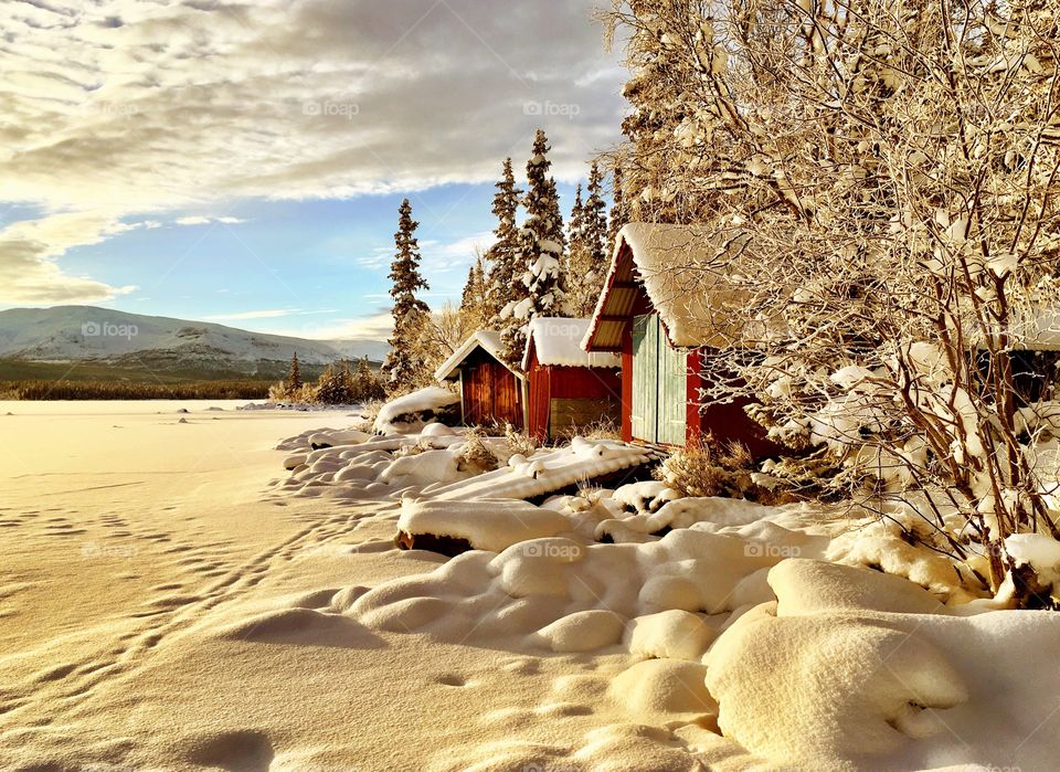 Snowy boathouses.