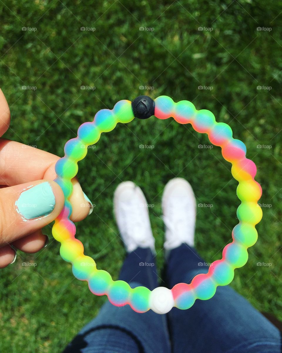 Here is a rainbow Lokai, with white converse below it!