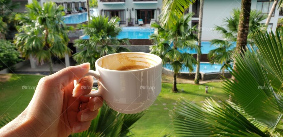 Enjoying cup of coffee at the tropical resort