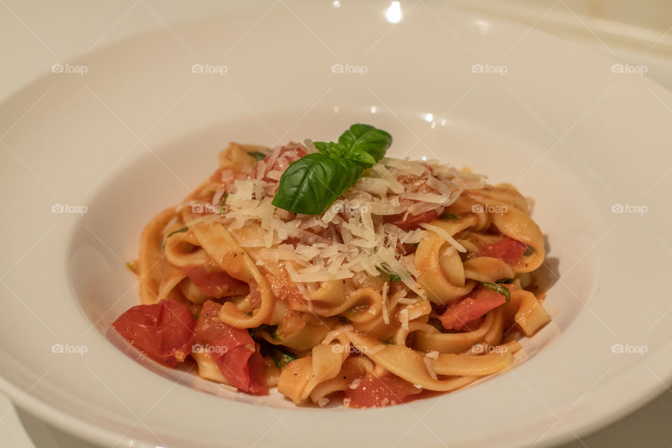 High angle view of pepperoni pasta with basil