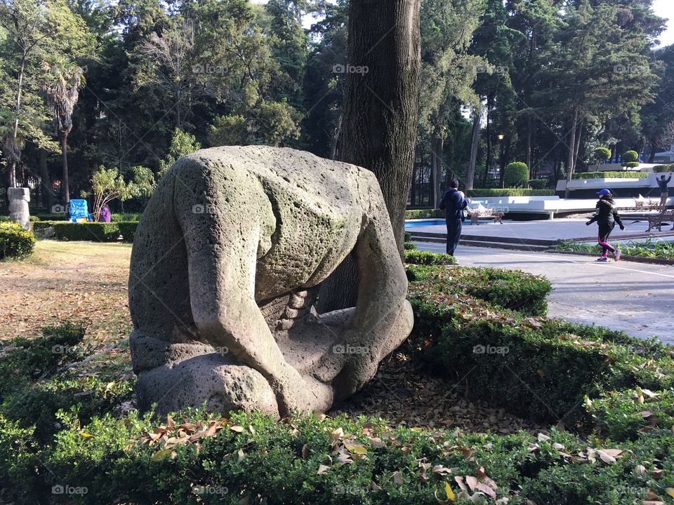 A replica of a prehispanic stone sculpture at a park in Mexico City. The way the head broke makes it look a little eary