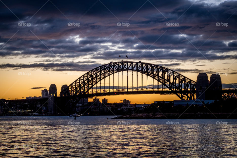 A hint of colour in the clouds over Sydney Harbour at dawn