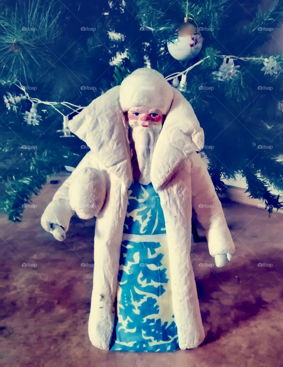 Our grandfather Frost is standing next to the tree.