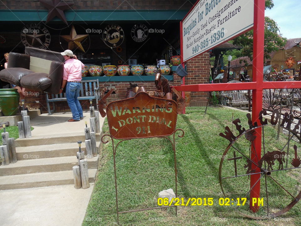 we don't dial 911. This is a picture of a sign for sale that I saw posted in front of a gift shop in Mineral Wells Texas