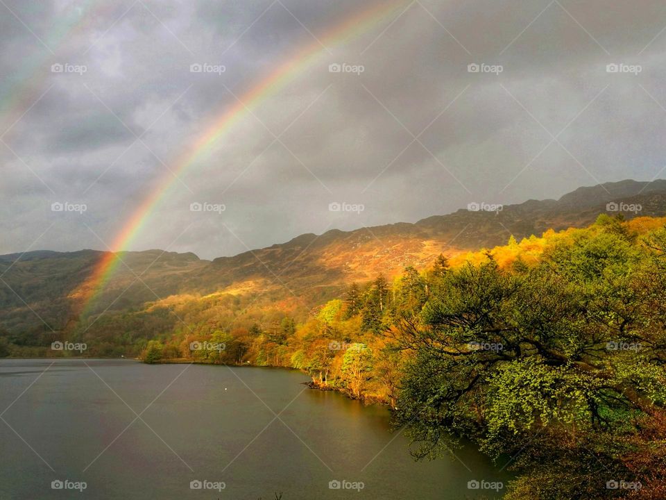 Autumn colours, autumn vibes. Rainbow. Beautiful autumn nature.Cloudy sky.