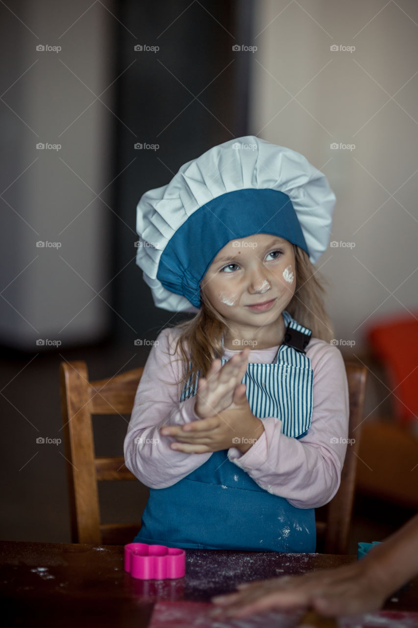 Little sisters cooking the biscuits 