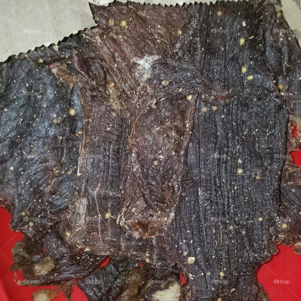 Beef biltongs chips, dried beef meat. Suitable as a snack when traveling. Moderate chili, spiced. Available at service station , quick shop, supermarket 