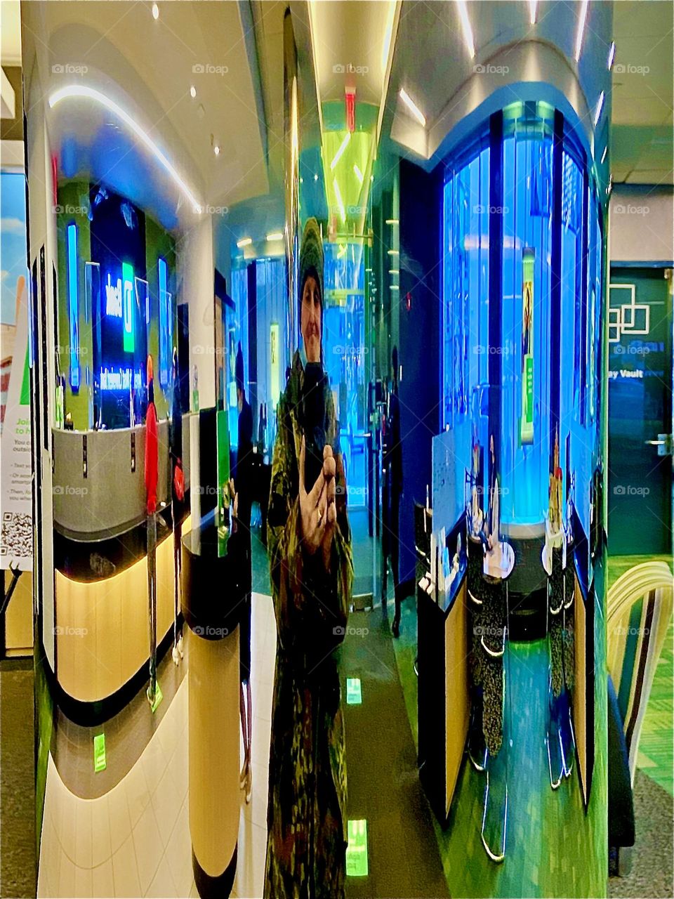 Timothy Trespas is at the bank ATM in our neighborhood in Long Island City, Queens, NY and took a picture of his reflection in a large shiny silvery chrome pole creating a surreal effect. 2021. Hypnotic Productions