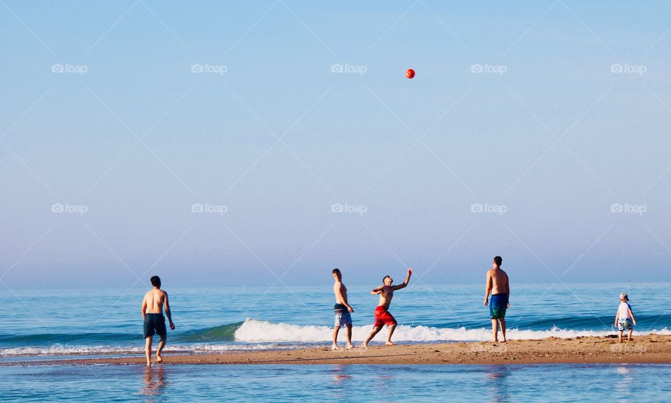 Playing soccer on the beach 
