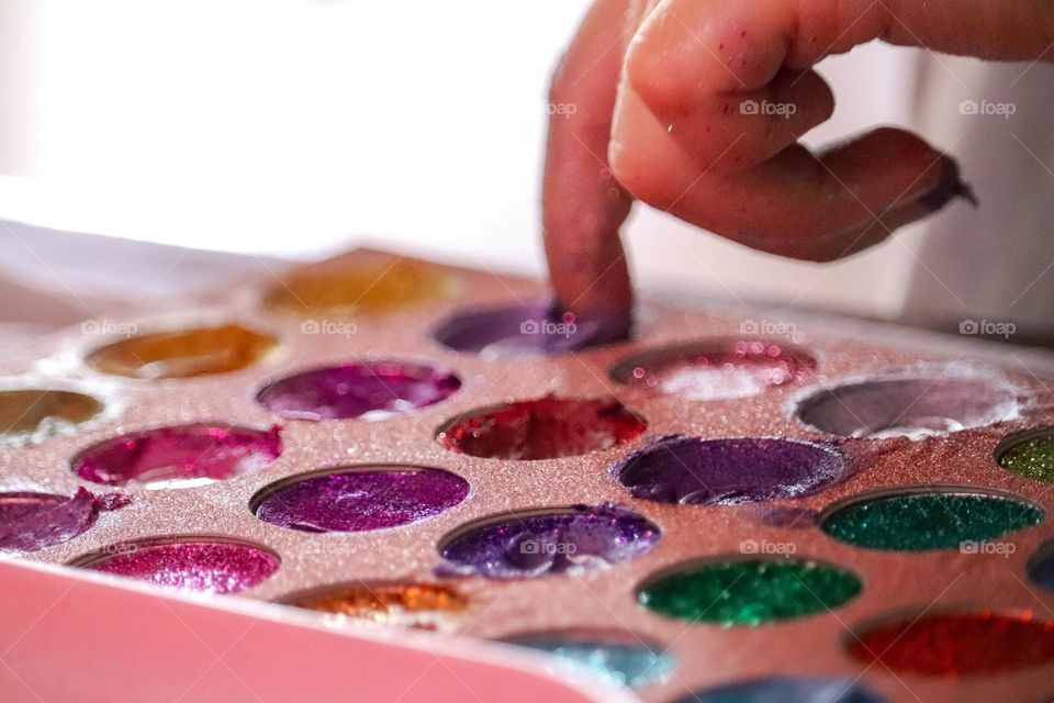 A child wearing glitter makeup