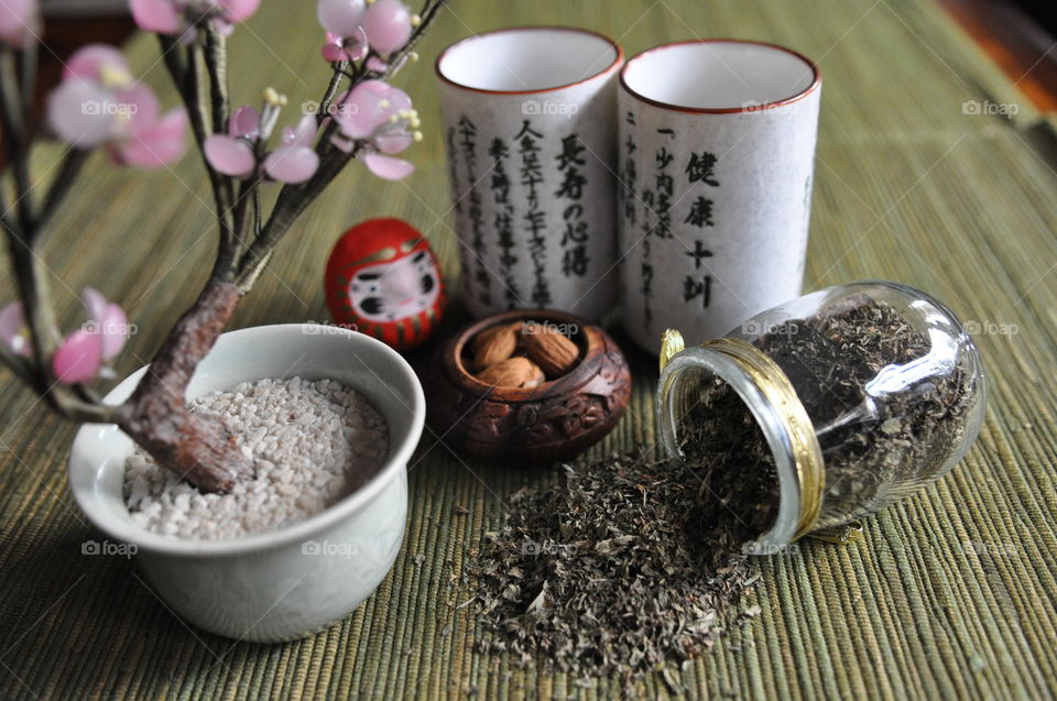 Close-up of herb and almonds on table