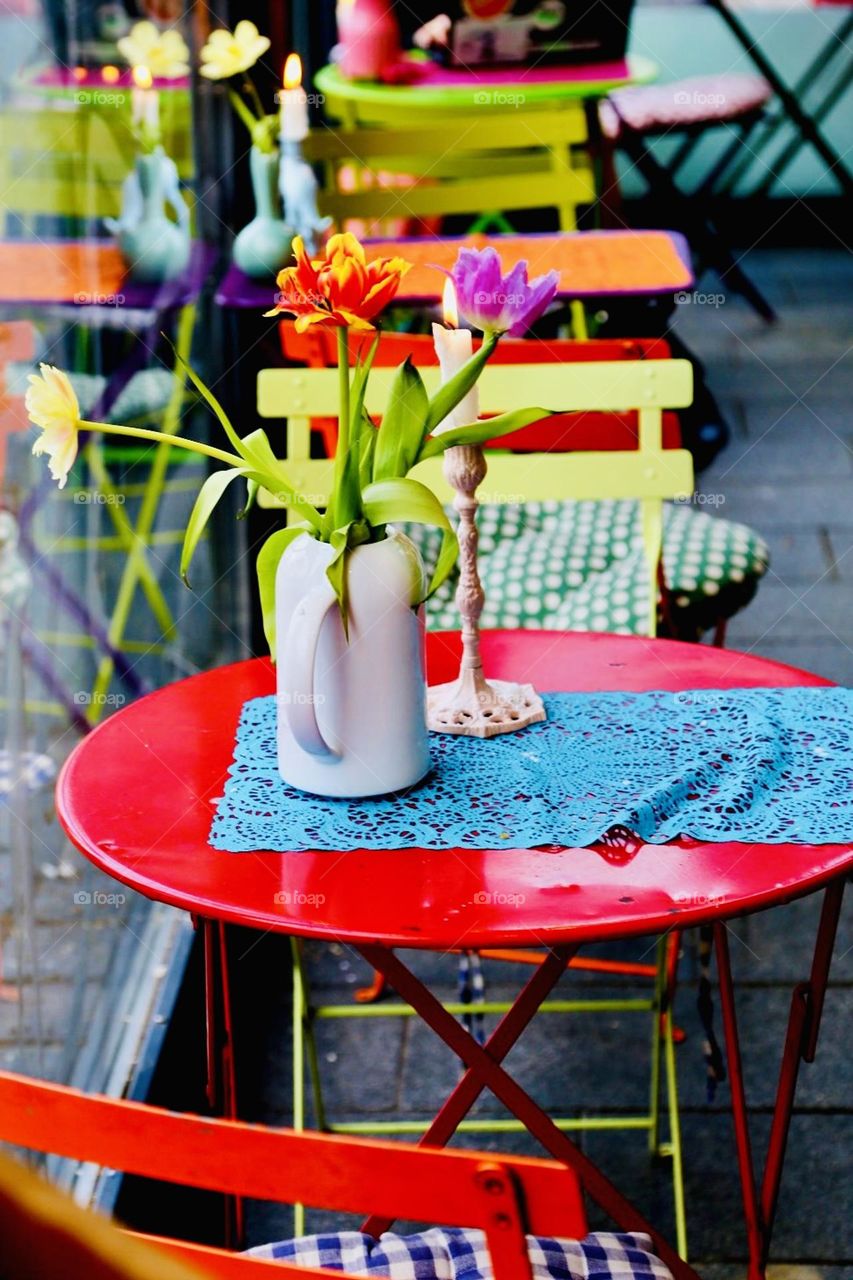Colorful furniture, flowers and fabric at a cafe
