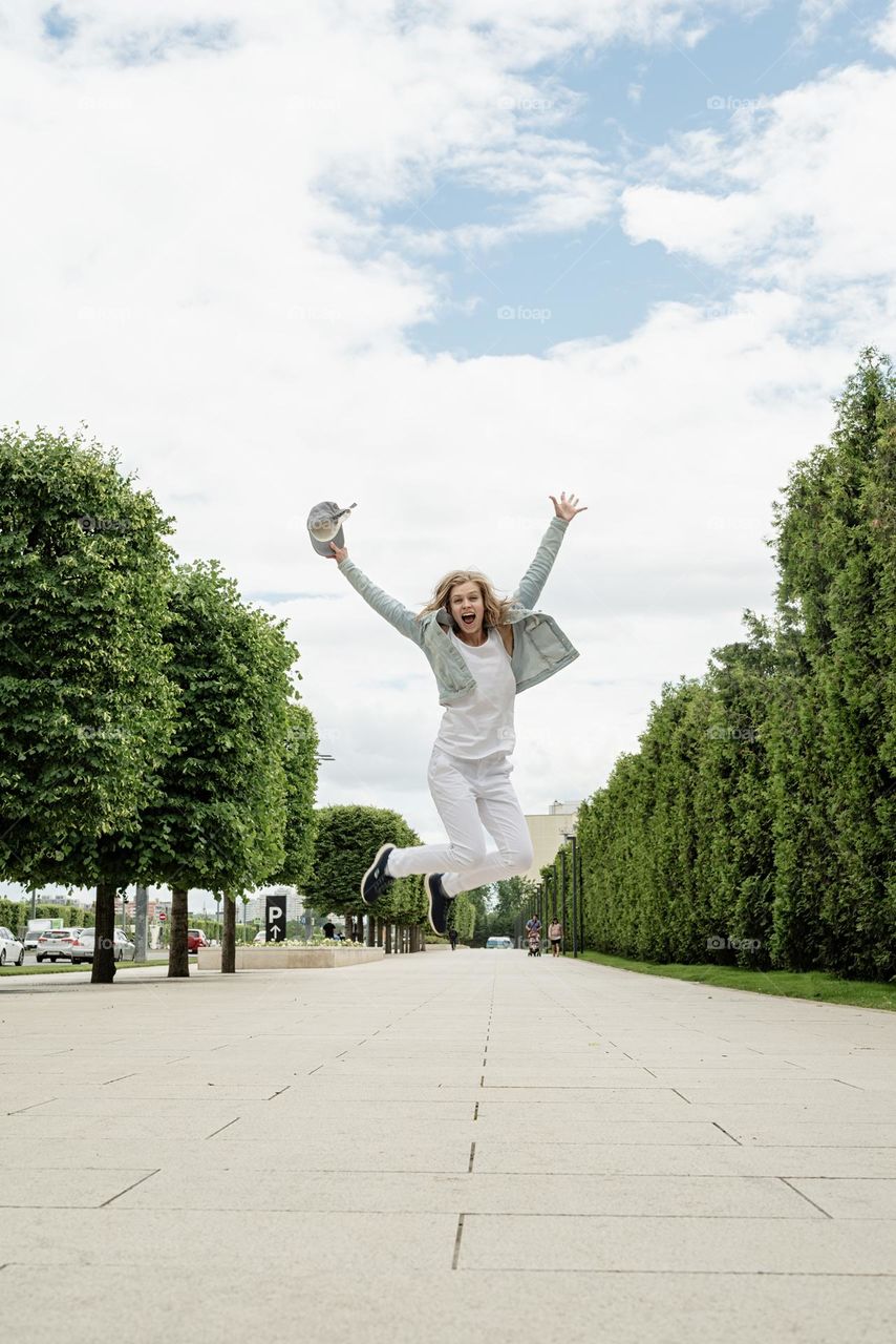 happy woman jumping at the street