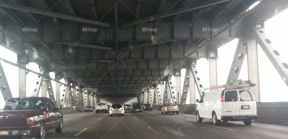 driving in a car on a covered bridge with traffic, double bridge, city commuting, city driving